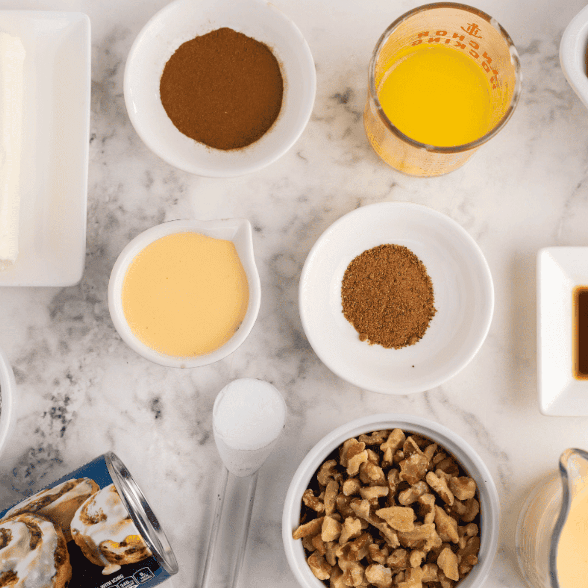 Ingredients needed for Air Fryer Eggnog Cinnamon Monkey Bread on kitchen table.