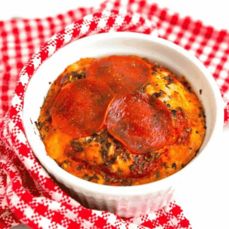 Air fryer mug pizza in a mug topped with melted cheese and pepperoni