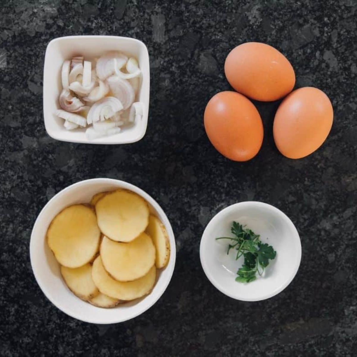 Ingredients needed for Easy Air Fryer Spanish Tortilla on kitchen table.