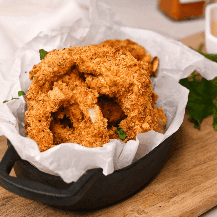 Crispy golden copycat Culver’s onion rings stacked on a plate, ready to serve
