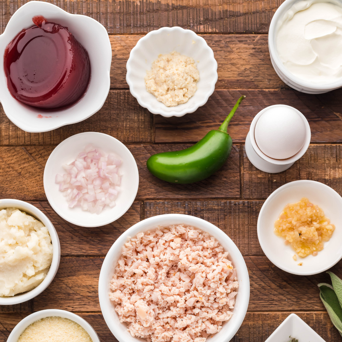 Cranberry sauce, sour cream, horseradish, jalapeno, and black pepper on a table