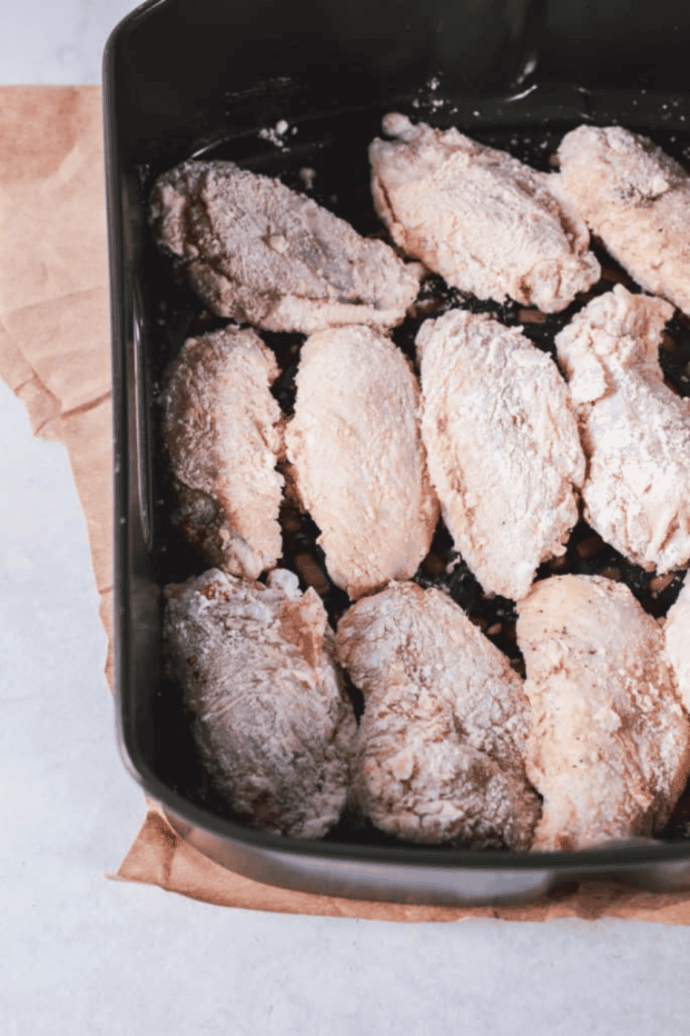 Chicken wings cooking in air fryer until golden and crispy