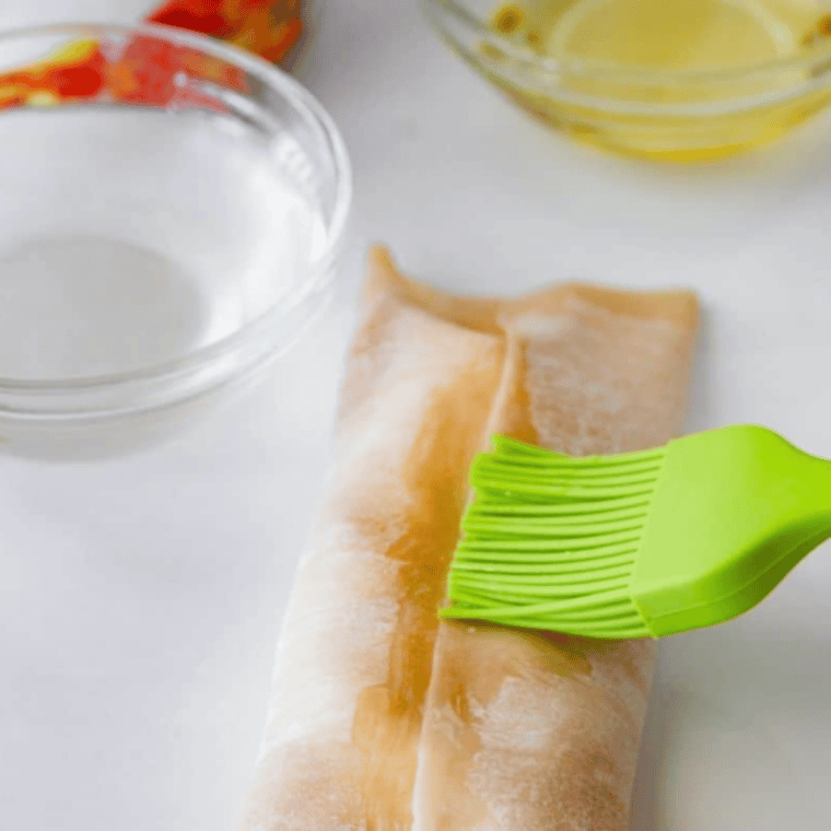 Lightly brushed egg rolls with olive oil ready for air fryer crisping