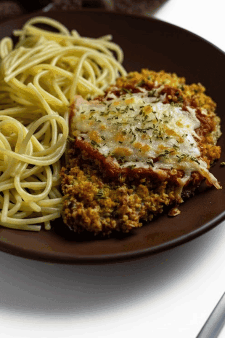 Crispy, golden brown breaded veal cutlets fresh out of the air fryer on a serving plate.