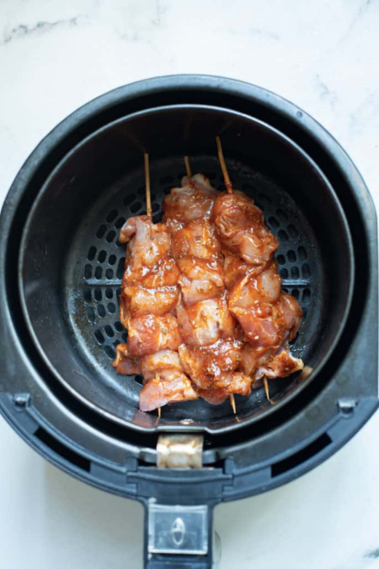 Bacon spiraled around a seasoned chicken tender secured with a toothpick