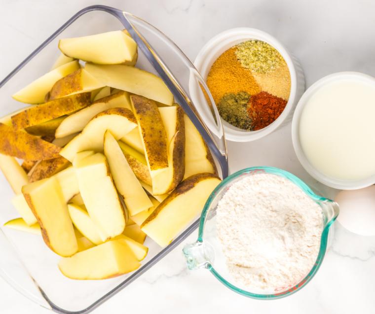 Russet potatoes, flour, olive oil, garlic powder, paprika, and seasonings for copycat Buffalo Wild Wings potato wedges