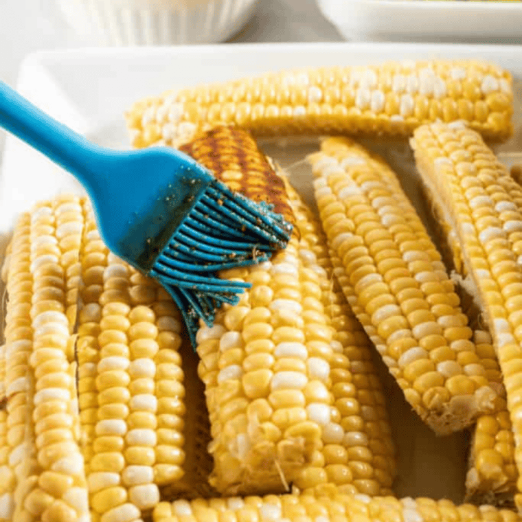 Brushing olive oil and spice mixture over corn ribs before air frying