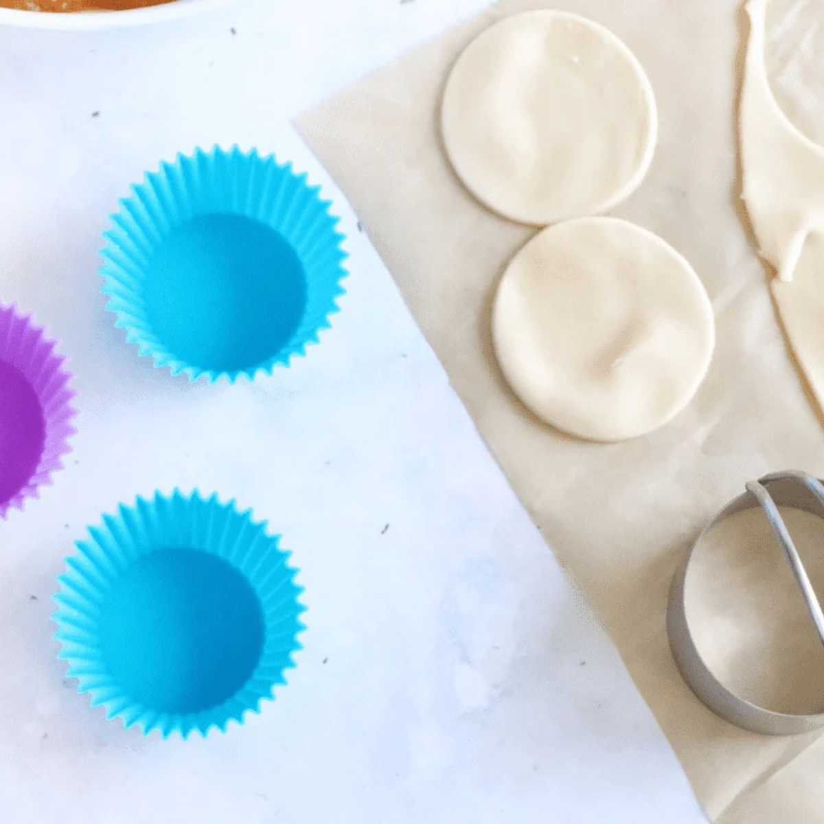 Unrolling refrigerated pie crust onto parchment paper