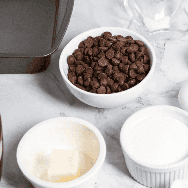 Ingredients for air fryer vegan brownies laid out: flax egg, vegan butter, sugars, vanilla, flour, cocoa powder, baking powder, salt, and dairy-free chocolate chips