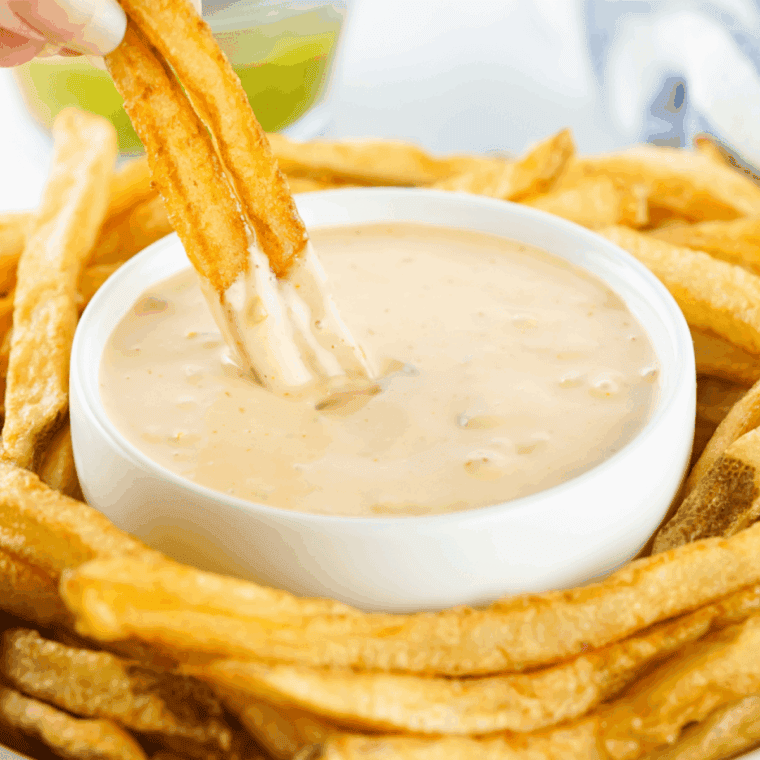 Small bowl of creamy Copycat Freddy’s Fry Sauce with a side of golden fries