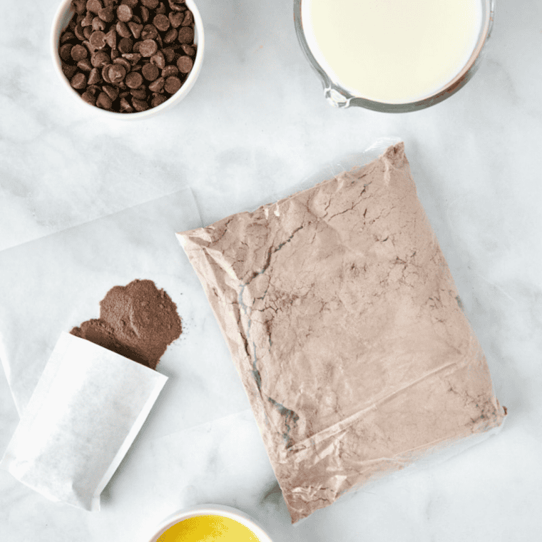 Ingredients for air fryer chocolate dump cake including chocolate cake mix, instant pudding, butter, milk, and chocolate chips