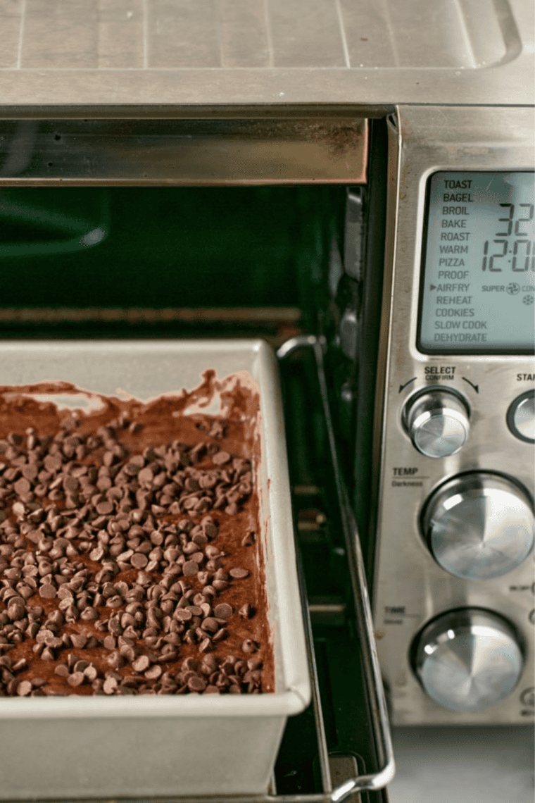 Chocolate dump cake in a cake pan inside an air fryer basket