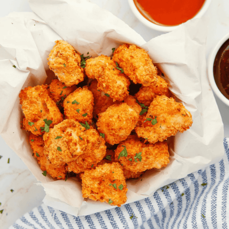 Crispy air fryer copycat KFC popcorn chicken served golden brown with dipping sauce.