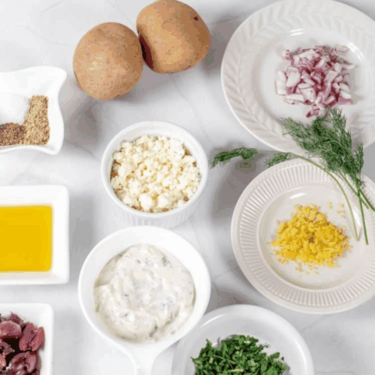 Ingredients for air fryer Greek fries: russet potatoes, olive oil, lemon, Greek seasoning, feta, and tzatziki