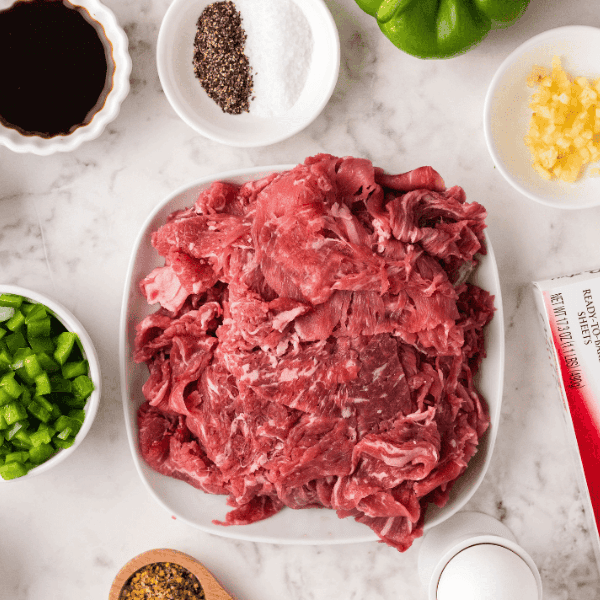 Ingredients needed for Easy Air Fryer Italian Beef Stromboli on kitchen table.