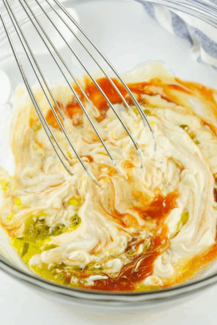 Whisking together all ingredients in a large bowl to make smooth Freddy’s fry sauce