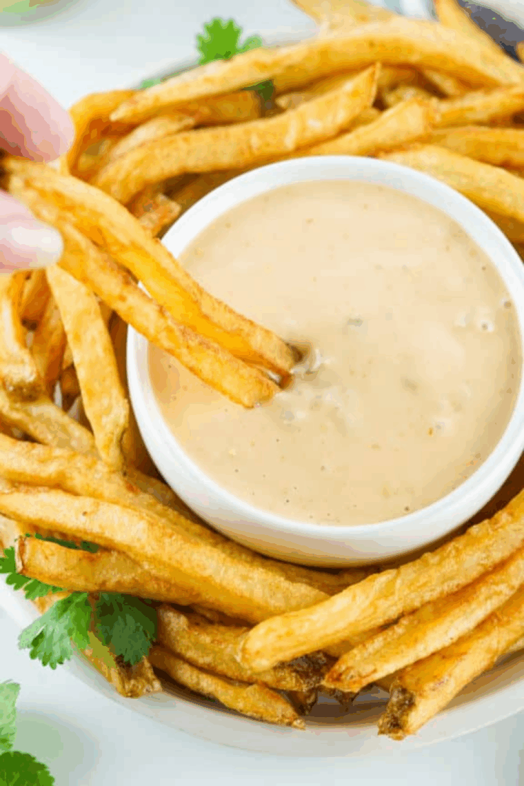 Small bowl of creamy Copycat Freddy’s Fry Sauce with golden fries on the side