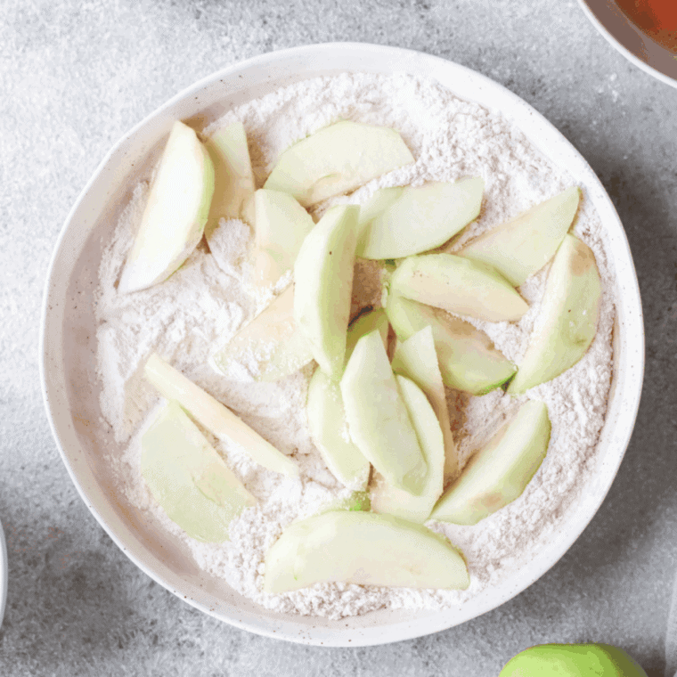 Apple slices coated in flour, dipped in egg mixture, then recoated.