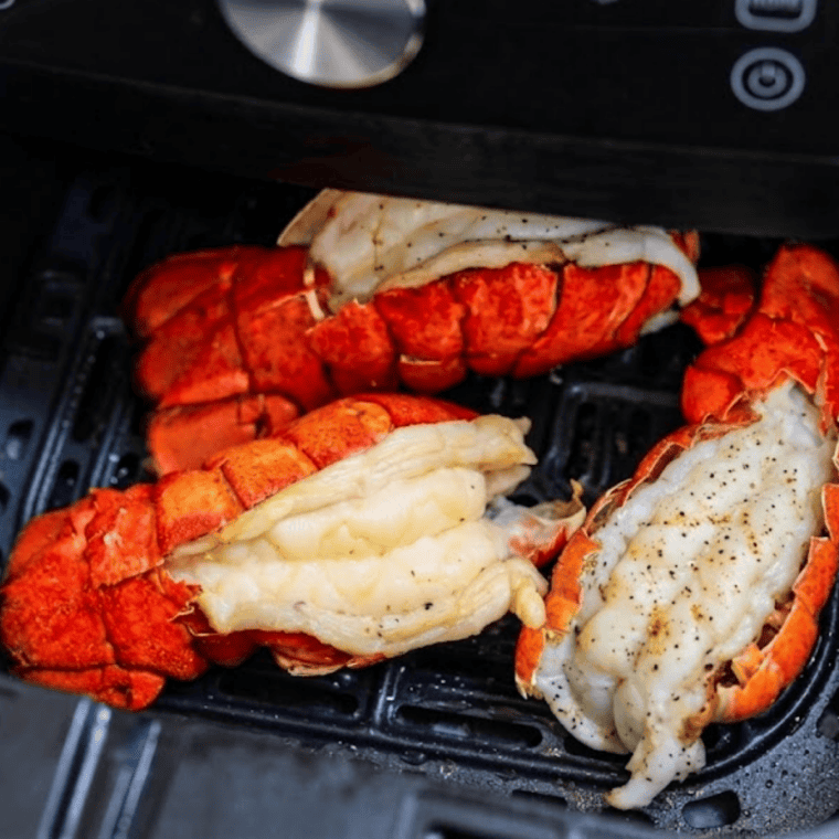 Butterflied frozen lobster tails brushed with garlic butter before air frying