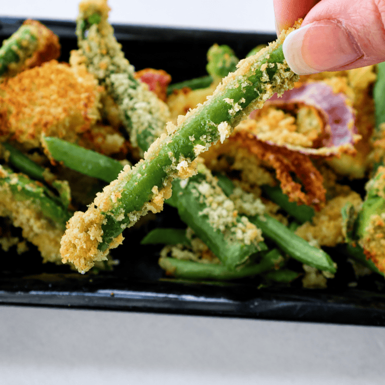 Plate of sliced raw vegetables prepped for air fryer tempura