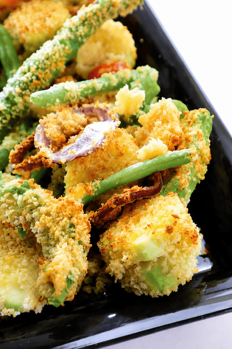 Plate of golden air fryer vegetable tempura with tentsuyu dipping sauce