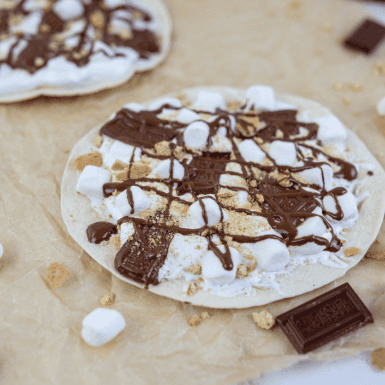 Blackstone Grill s’mores pizza topped with melted chocolate, toasted marshmallows, and graham cracker pieces