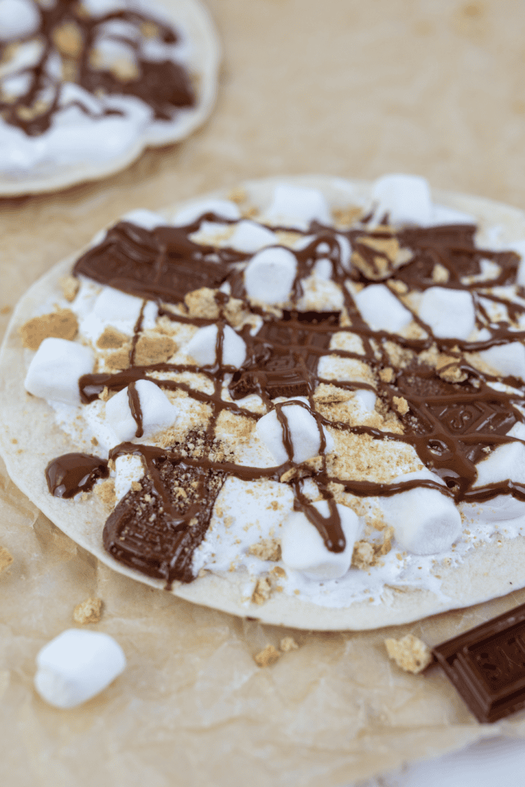 Blackstone Grill s’mores pizza with melted chocolate, toasted marshmallows, and graham crackers on a golden crust