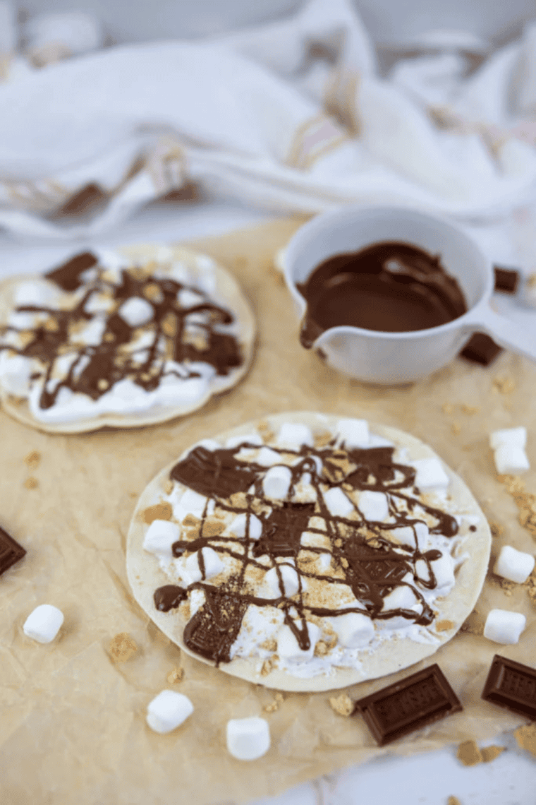 Blackstone Grill s’mores pizza topped with melted chocolate, toasted marshmallows, and crushed graham crackers