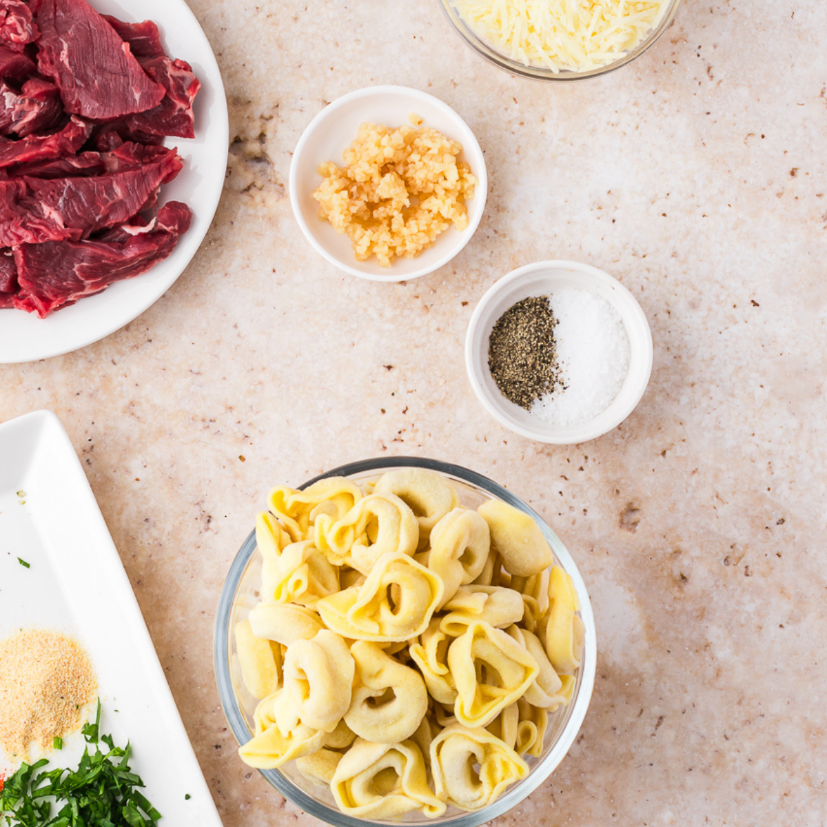 Ingredients needed for Easy Blackstone tortellini recipe on kitchen table.