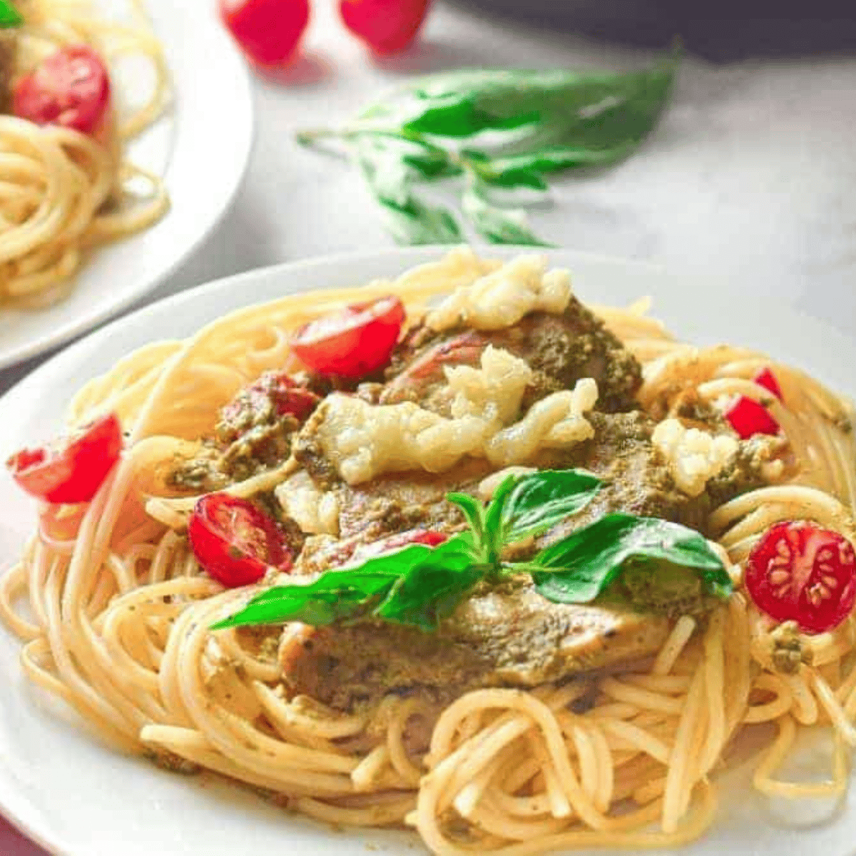 Instant Pot pesto chicken pasta with tender chicken, pasta, and creamy green pesto sauce served in a bowl