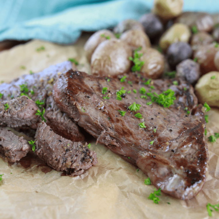 Juicy Blackstone sirloin steak with a crispy seared crust sliced and served on a cutting board