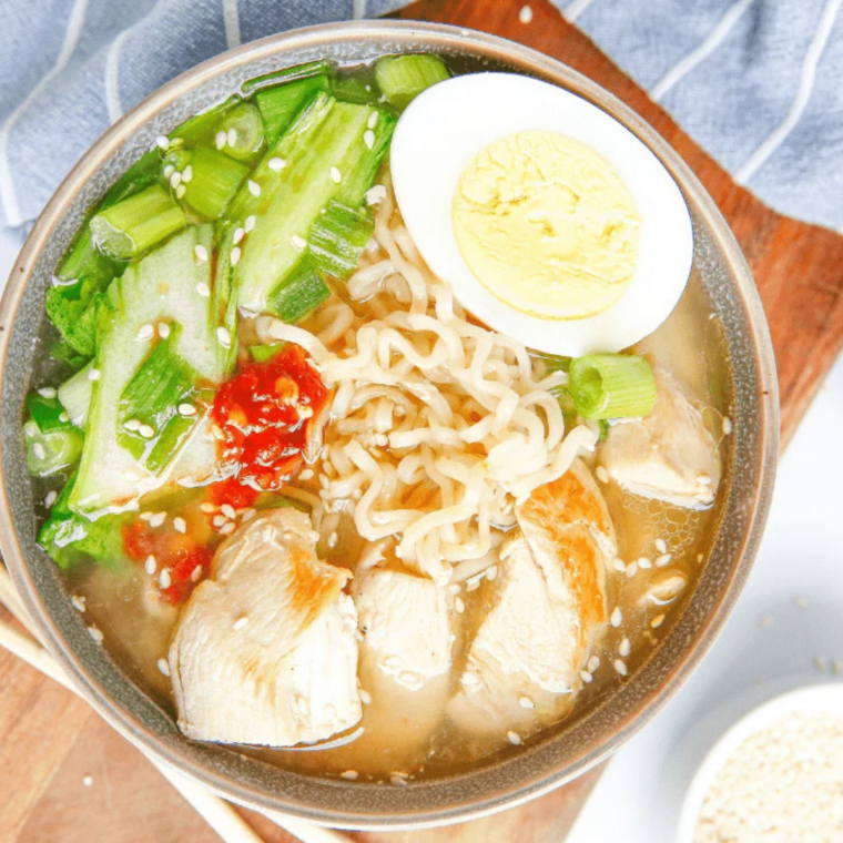 overhead view of a bowl of slow cooker chicken ramen with egg, chicken and nori