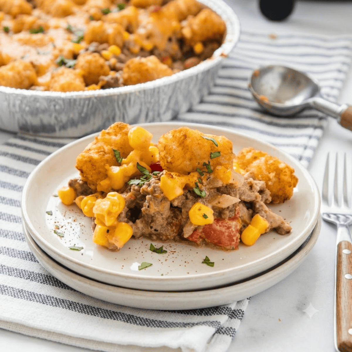 Air fryer cowboy casserole with crispy golden tater tots over cheesy ground beef and corn