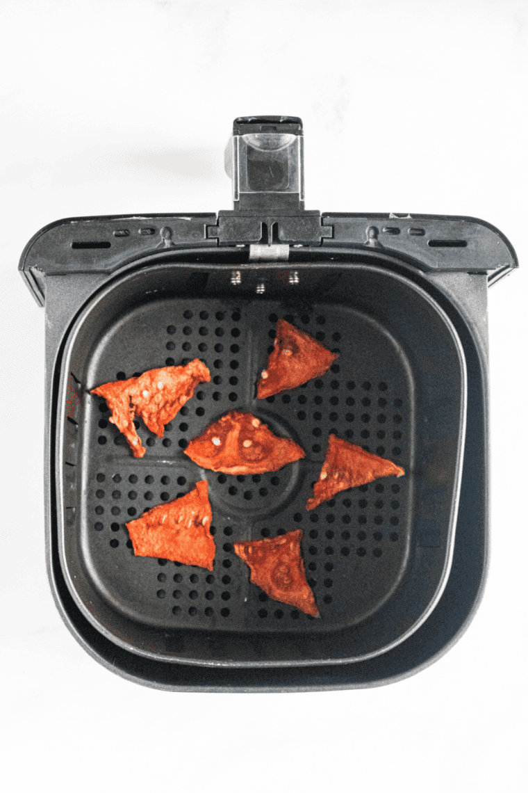 Watermelon slices arranged in a single layer in an air fryer basket