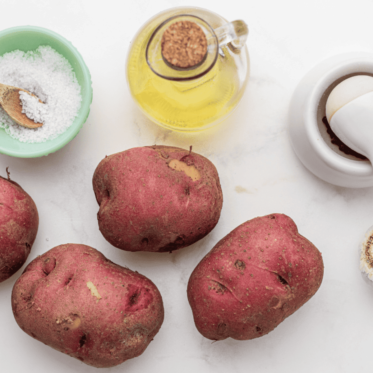 Ingredients needed for Air Fryer Roasted Potatoes and Tomatoes on kitchen table.