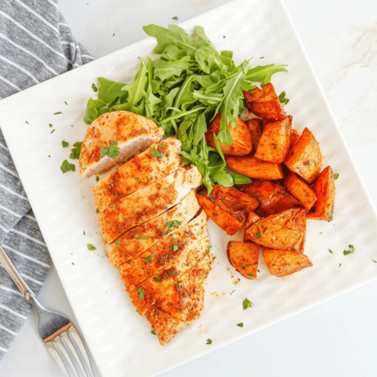 Blackstone chicken breast sizzling on a hot griddle