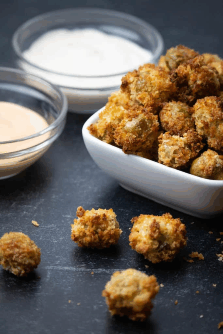 Golden, crispy air fryer fried olives served in a small bowl, ready to enjoy as a snack or appetizer.