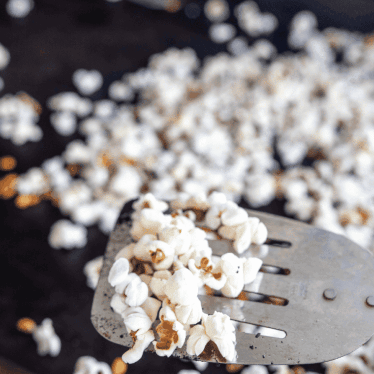 Popcorn popping on the Blackstone griddle under a metal dome