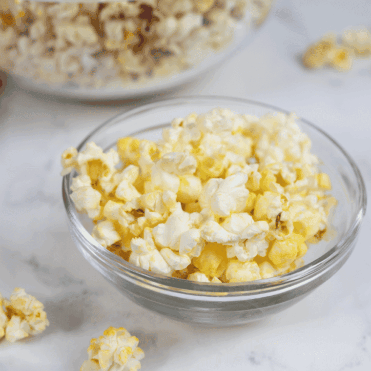 Bowl of buttery Blackstone popcorn fresh off the griddle on a kitchen table
