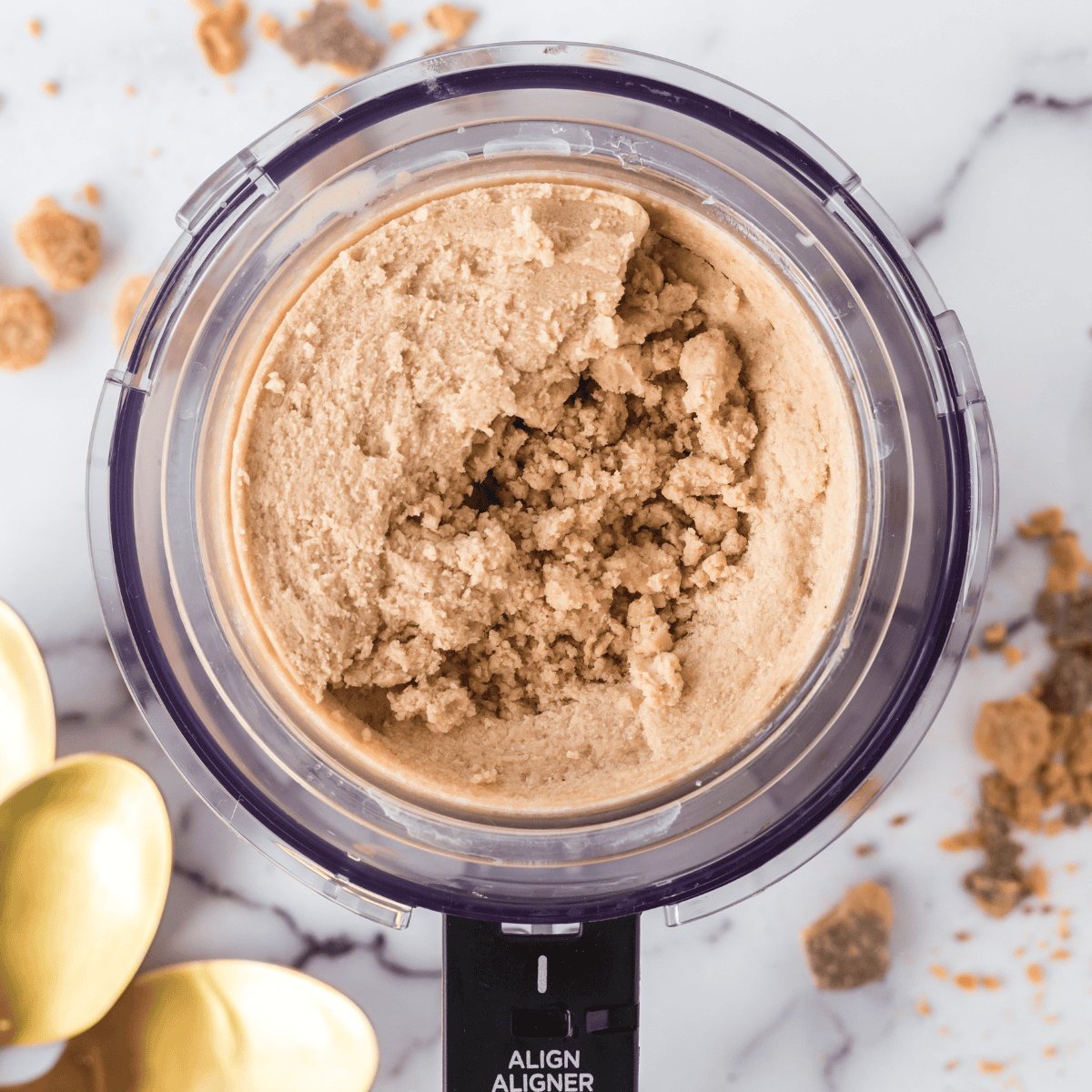 Pouring cookie butter ice cream mixture into Ninja Creami pint container and freezing for 24 hours