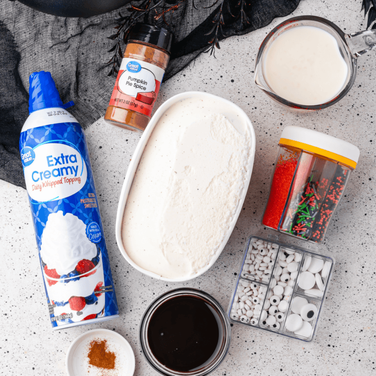 Ingredients for a Ninja Creami vanilla milkshake on a table: vanilla ice cream, milk, and vanilla extract