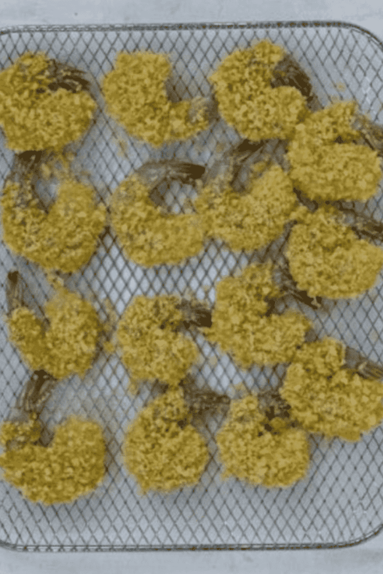 Shrimp being coated in seasoned flour mixture and prepped for air frying, with air fryer preheating to 400°F for crispy cooking.
