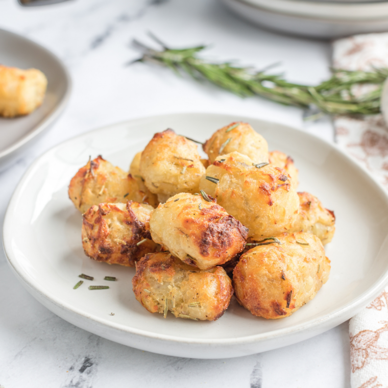Crispy smashed potatoes cooking on Blackstone griddle until golden brown and crunchy