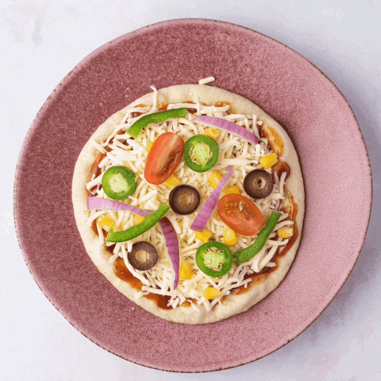 Add toppings on the pizza sauce and cheese.