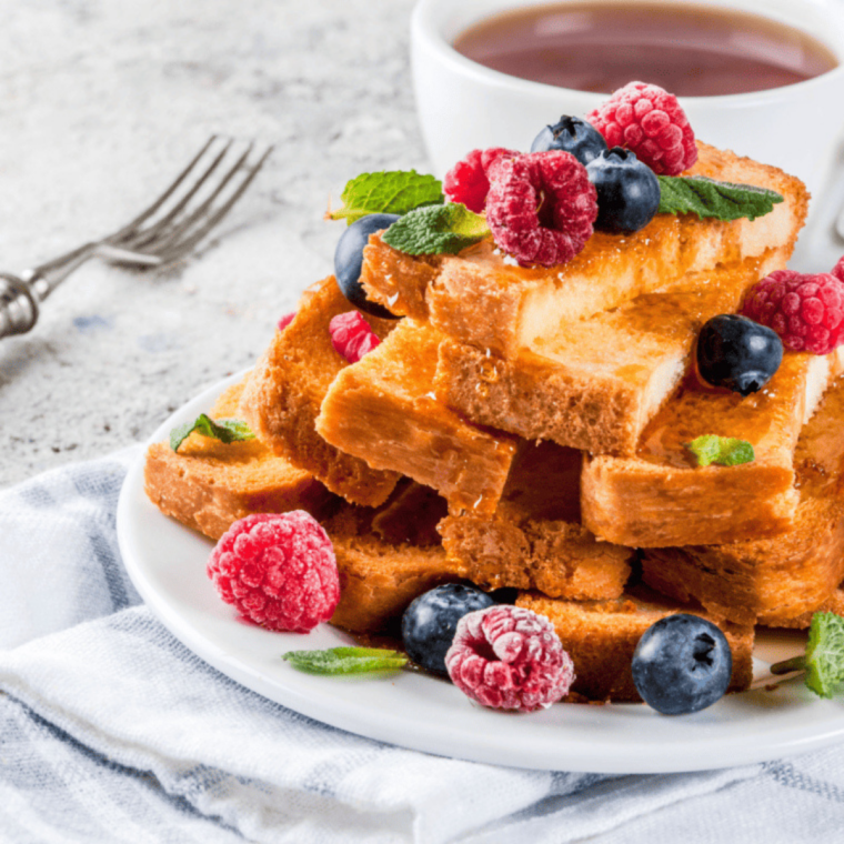 Air fryer French toast sticks, golden brown and crispy, served with syrup