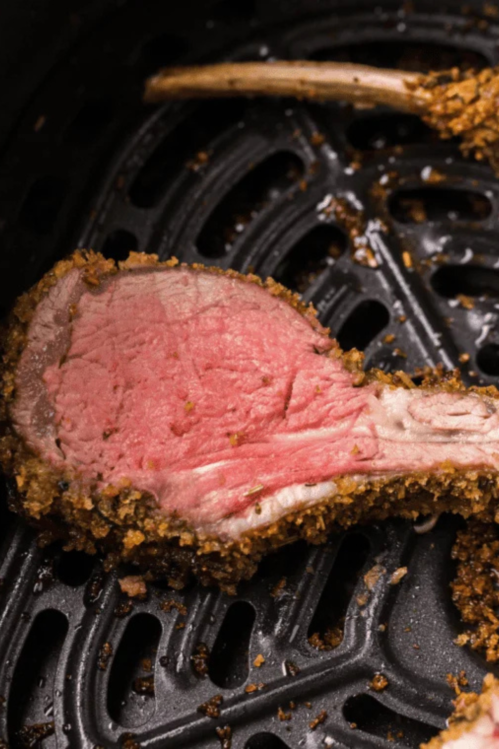 Lamb chops reheating in an air fryer basket