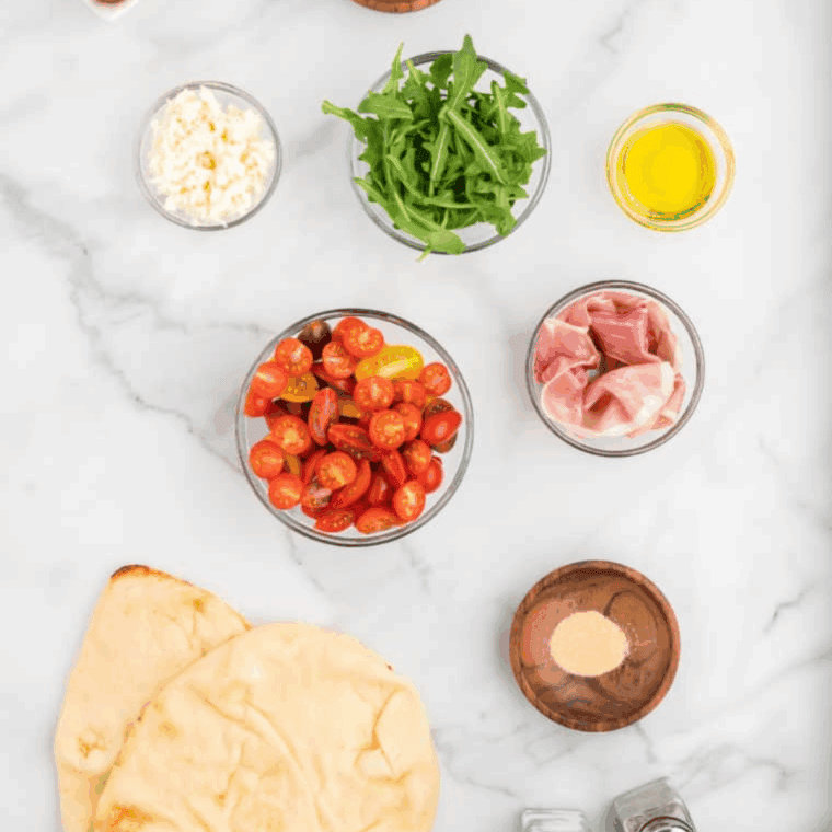 Ingredients needed for Air Fryer Breakfast Flatbread Pizza on kitchen table.