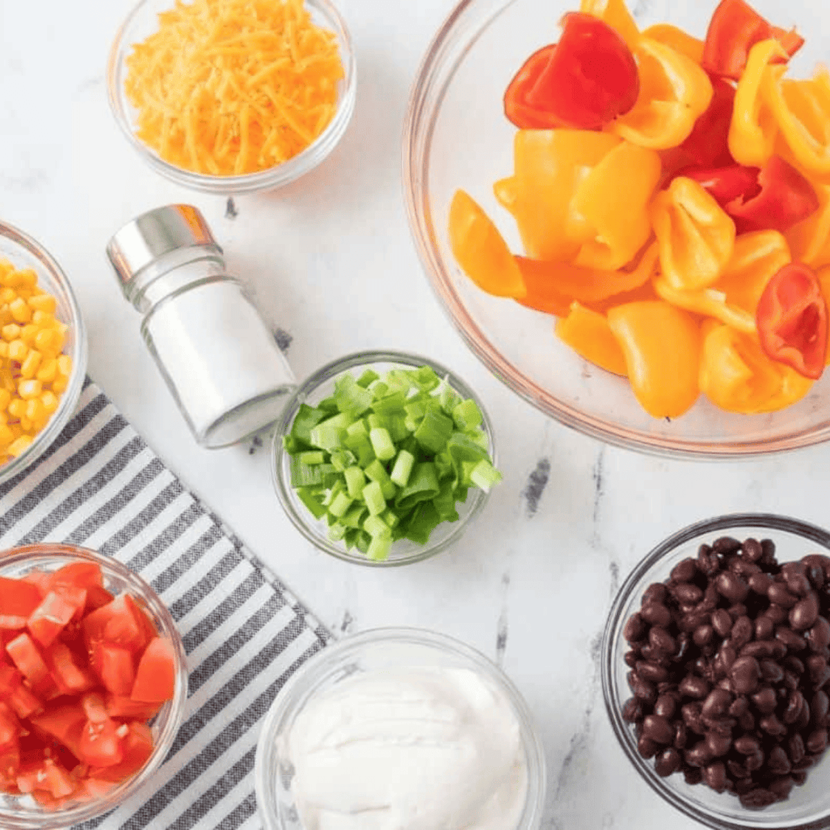 Ingredients needed for Easy Air Fryer Stuffed Mini Peppers on kitchen table.