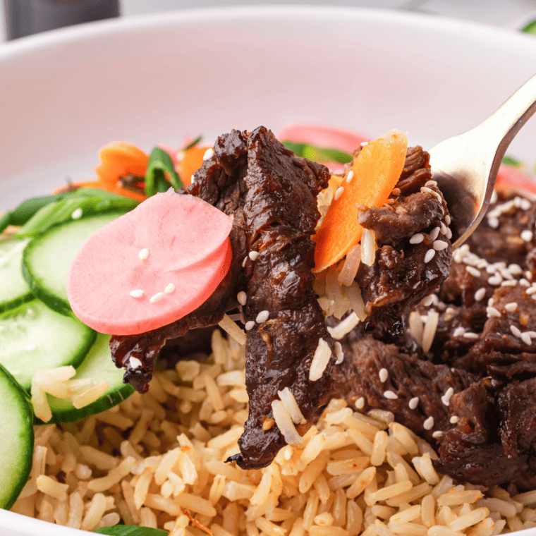 Air Fryer Trader Joe's Bool Kogi served with rice and sautéed vegetables on a white plate