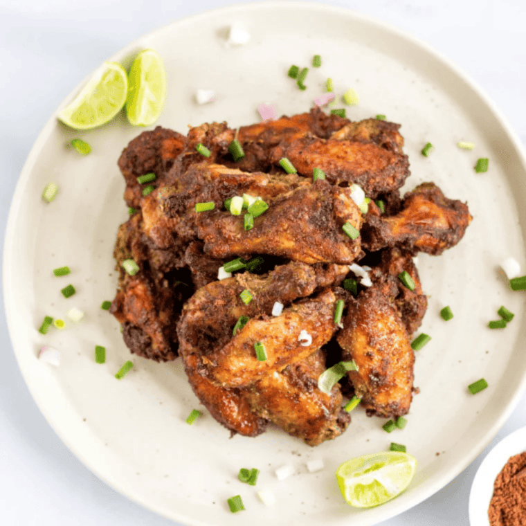 Crispy Copycat Wingstop Cajun Chicken Wings piled on a plate, seasoned with bold Cajun spices and ready to serve.